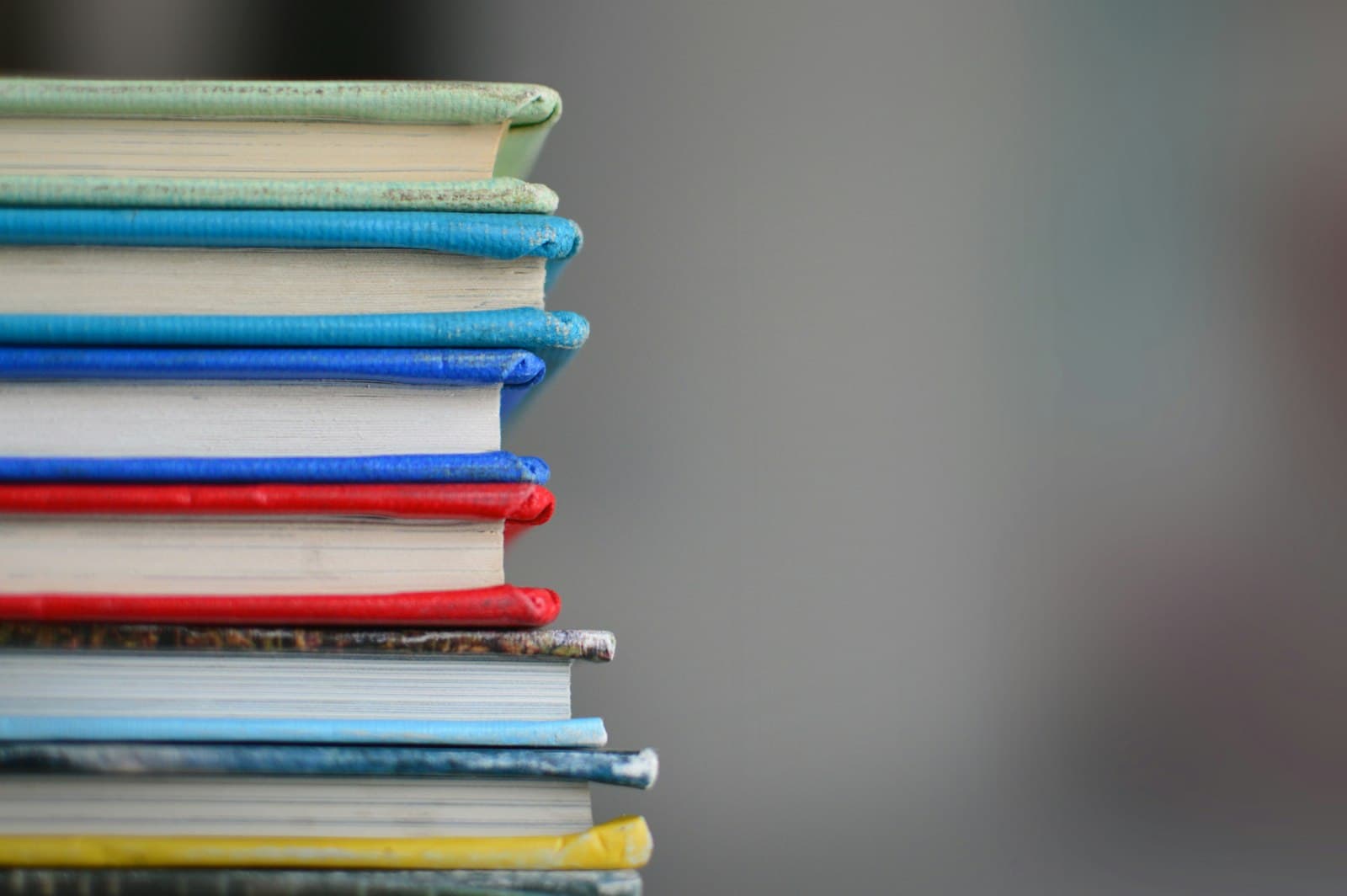 A stack of colourful textbooks photographed up close