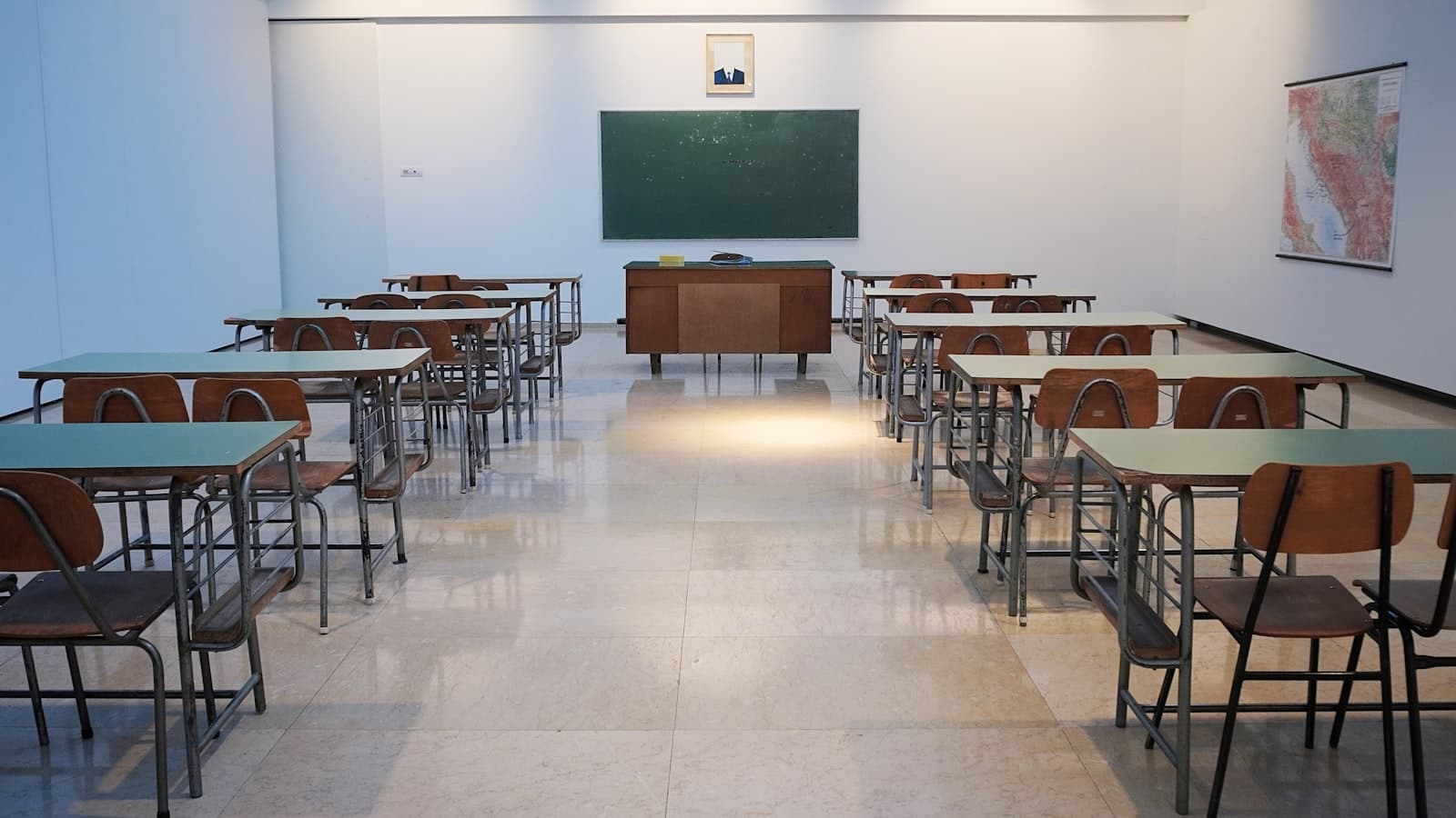A quiet classroom with rows of benches, ready for the next batch